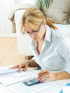 individual Tax Preparation - Image of Woman working on taxes